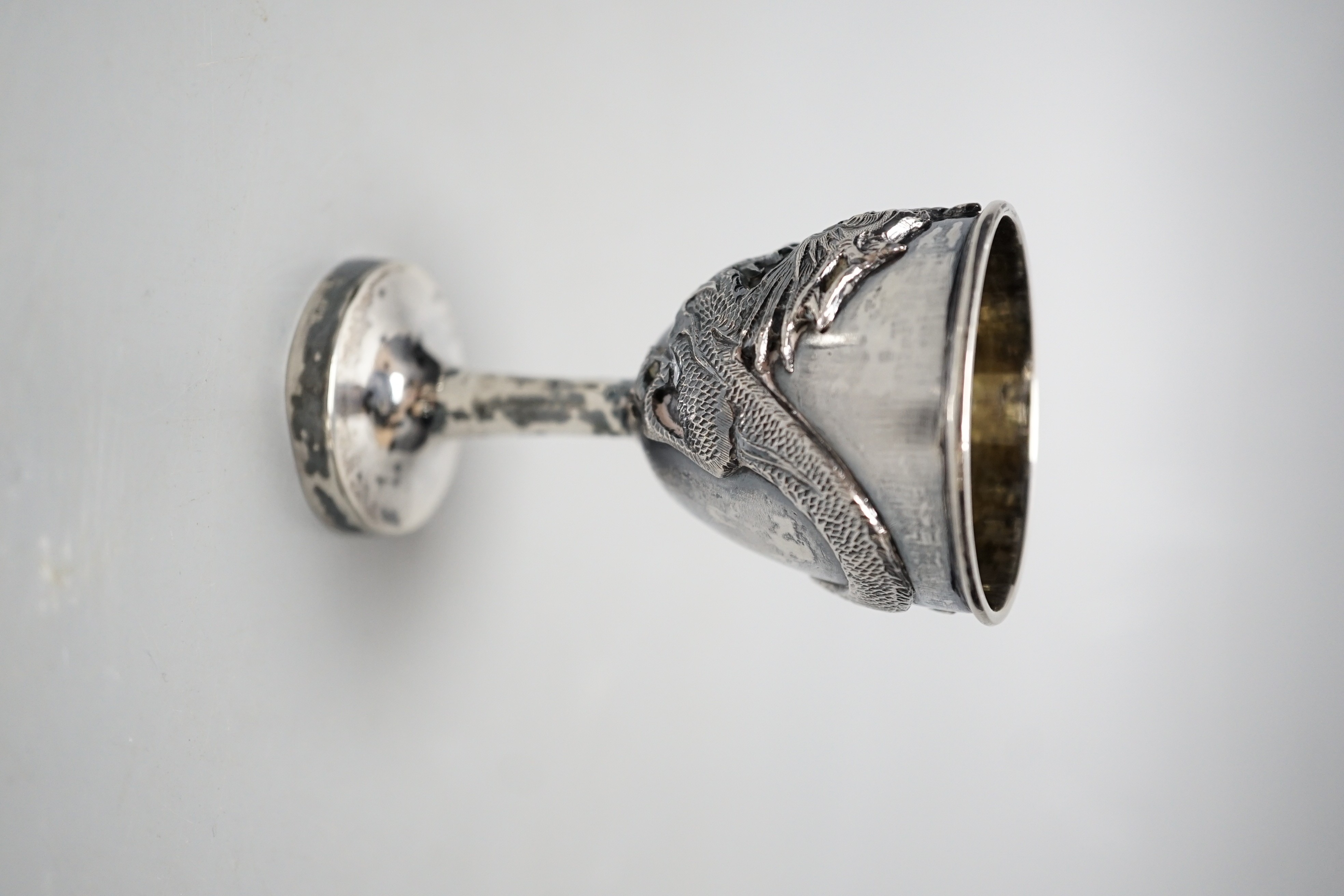 An early 20th century Chinese Export white metal dragon ‘egg’ cup and spoon, by Zee Shun, cup 76mm.